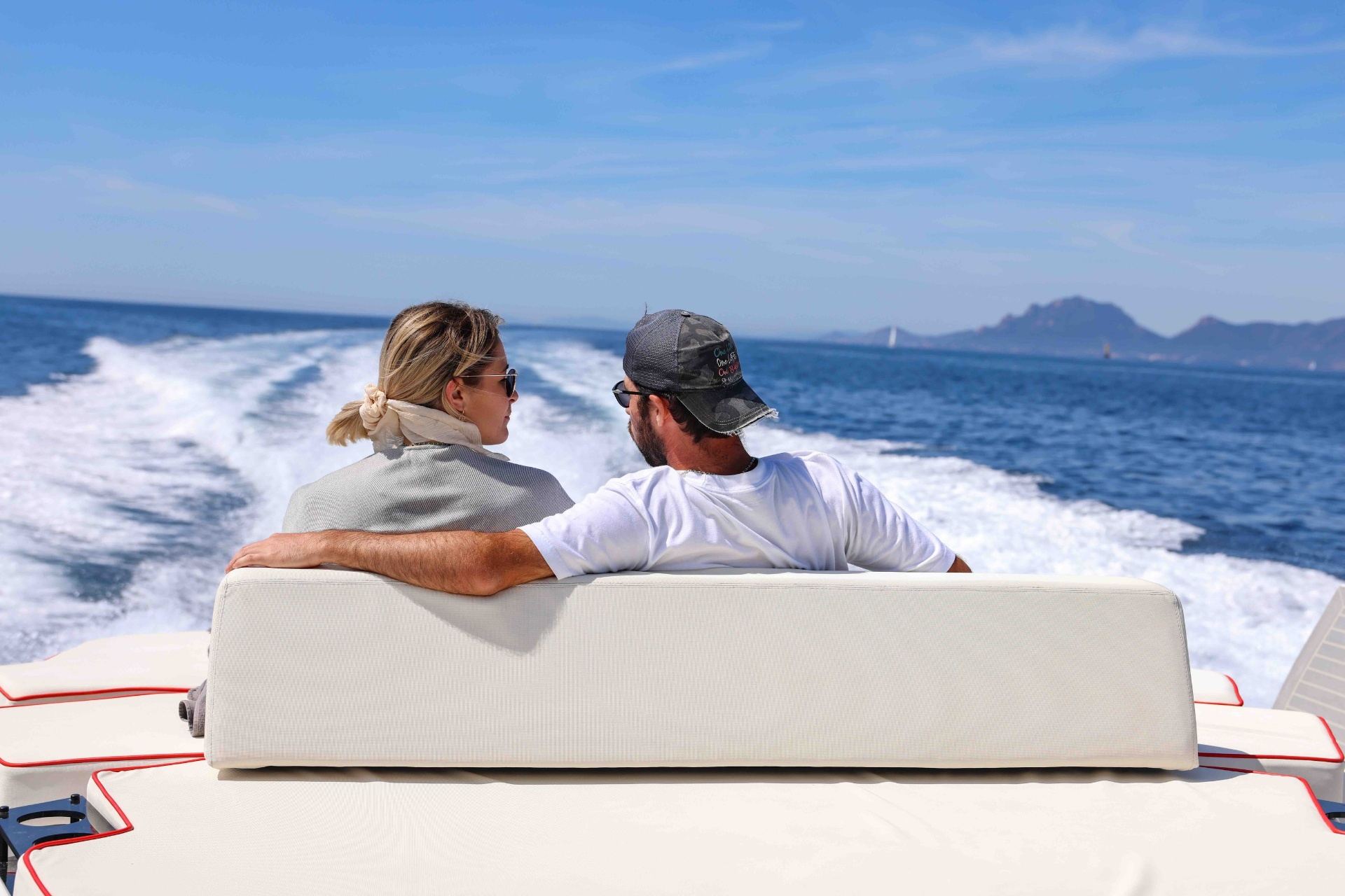 Couple enjoying a luxury yacht cruise along the French Riviera coastline