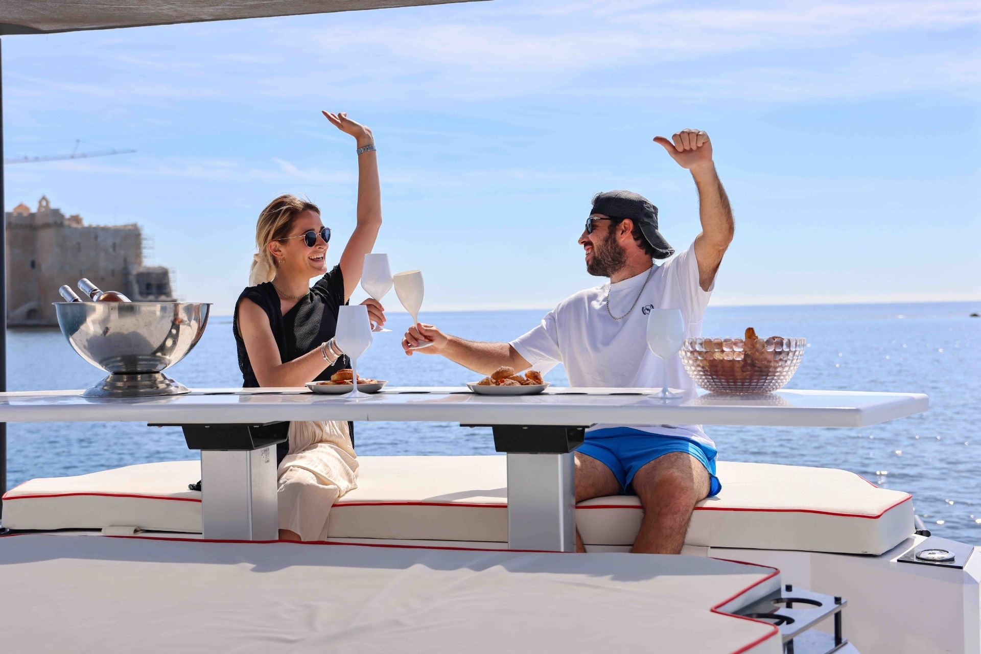 Friends cheering with white wine on yacht deck
