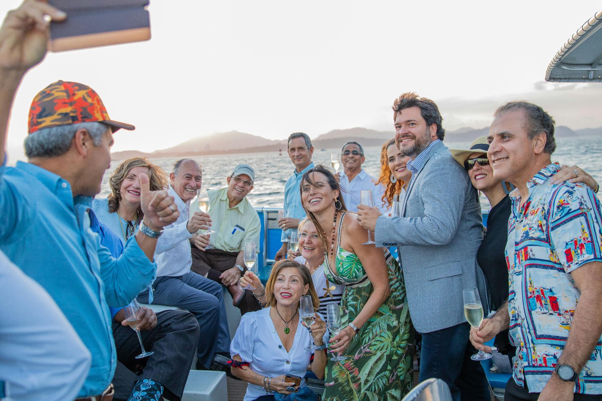 Group of friends celebrating with champagne on boat