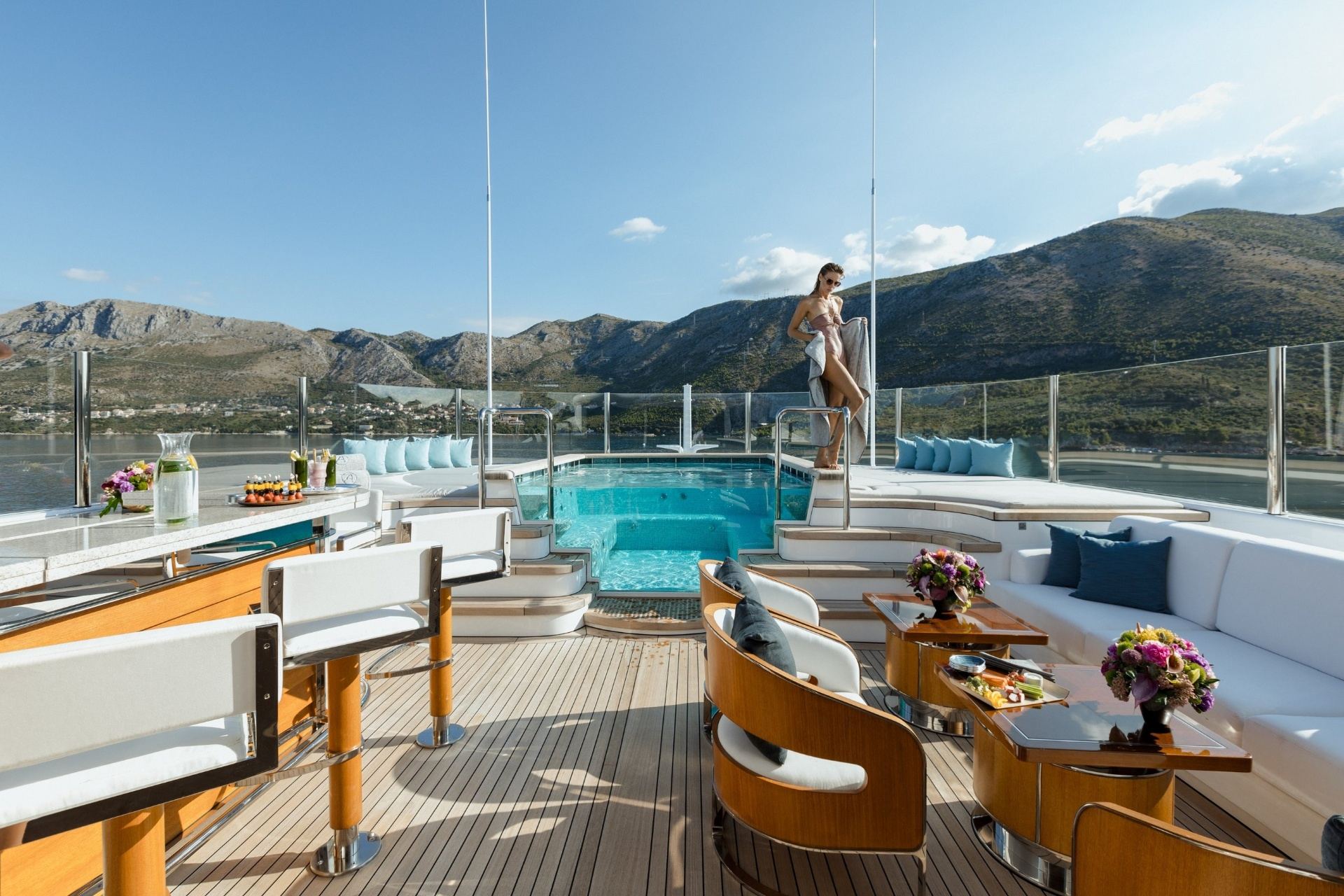 Superyacht pool deck with mountain backdrop
